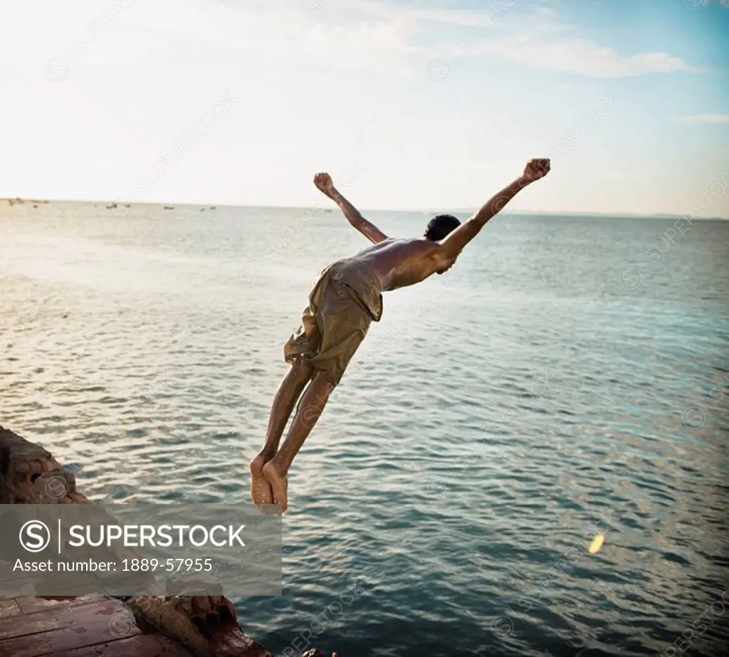 Boy jumping into the ocean, Salvador, Bahia, Brazil