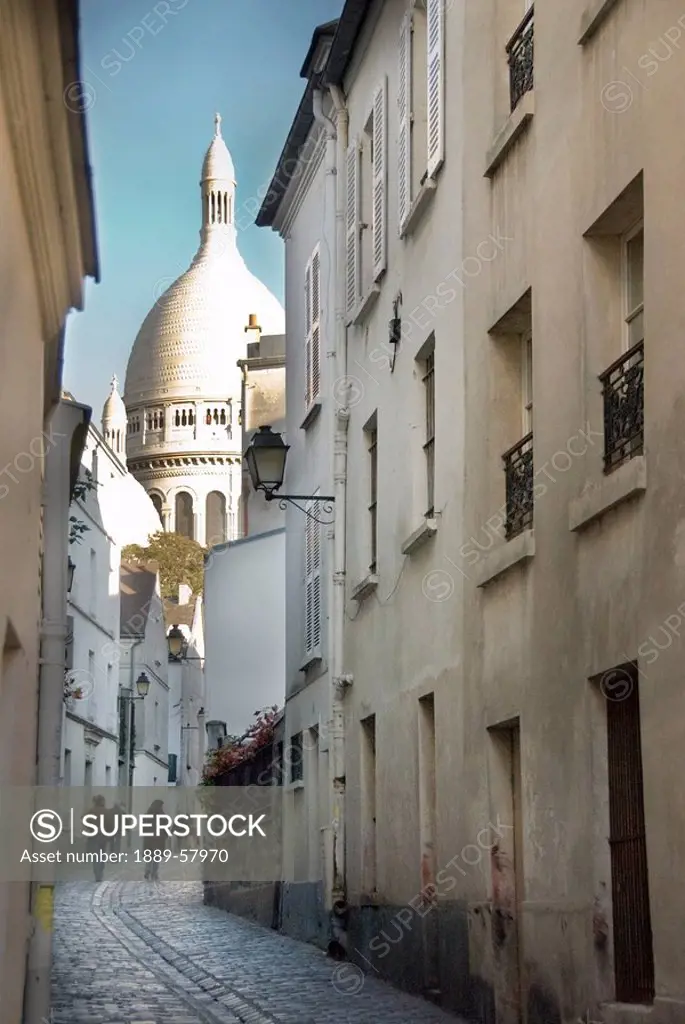 Sacre_Coeur Basilica at end of narrow street, Montmartre, Paris, France