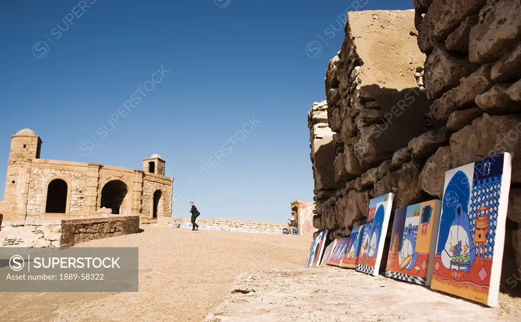 Paintings leaning against city wall, Essaouira, Morocco