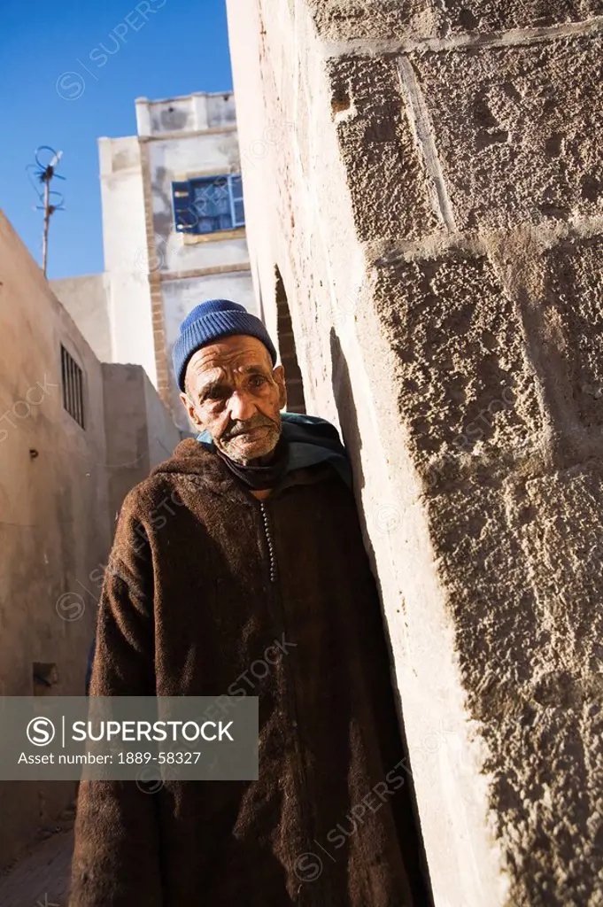 Senior male leaning against a wall, Essaouira, Morocco