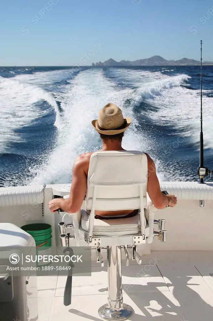 Man relaxing on boat, Cabo San Lucas, Mexico
