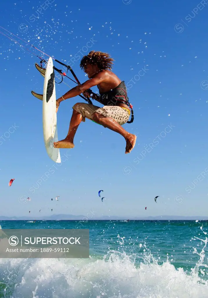 Young man kite surfing