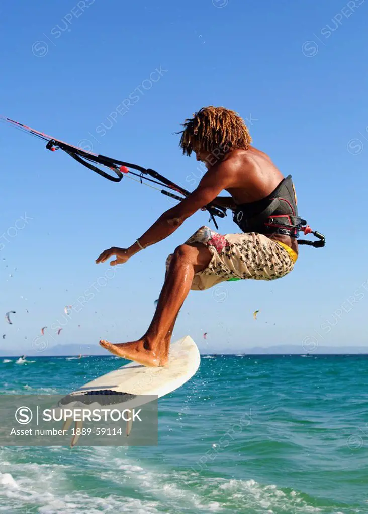 Young man kite surfing