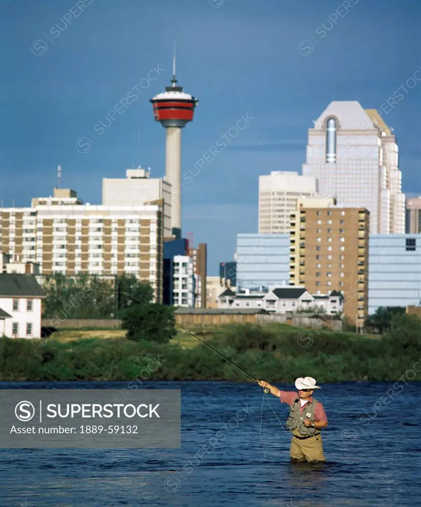Man fishing in the Bow river, Calgary, Alberta, Canada