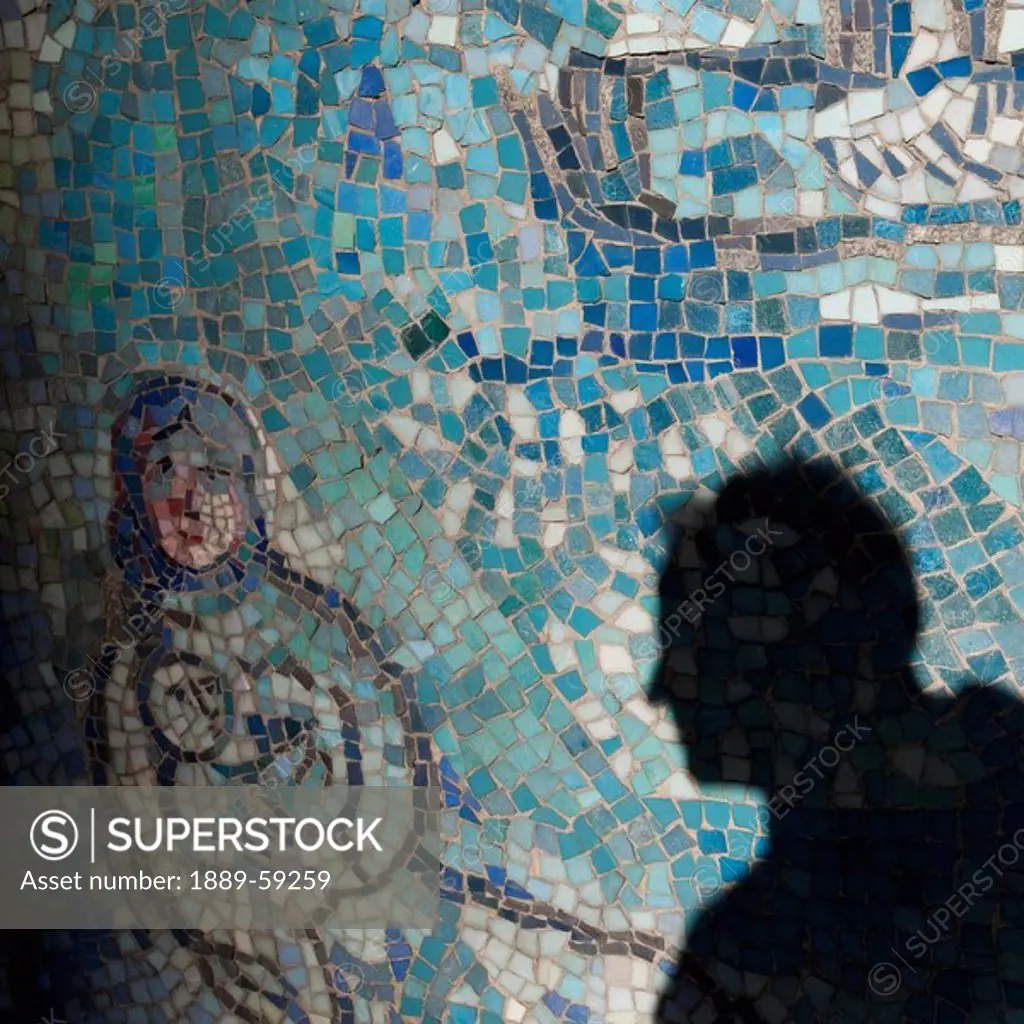 Shadow of man on mosaic tiles