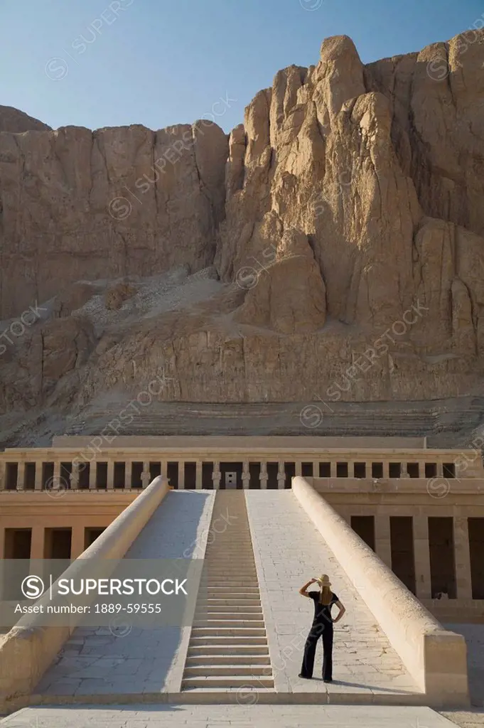 Woman tourist gazes at the Temple of Hapshetsu, Nile Valley, Egypt