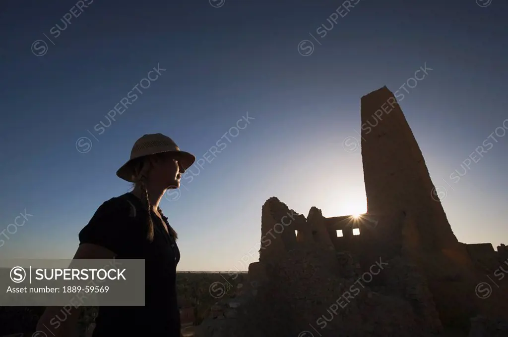 Woman tourist at The Temple of the Oracle Temple of Amun, Siwa Oasis, Egypt