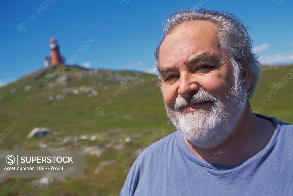 Man at lighthouse, Trespassey, Newfoundland, Canada