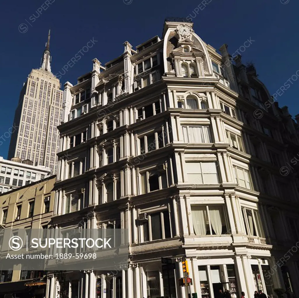Building facade with Empire State Building in background, Manhattan, New York, USA