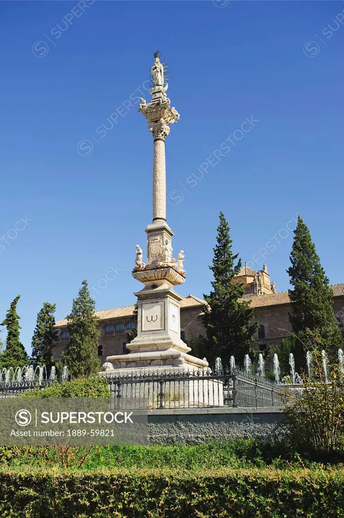 Fuente del Triunfo statue and Royal Hospital, Granada, Spain