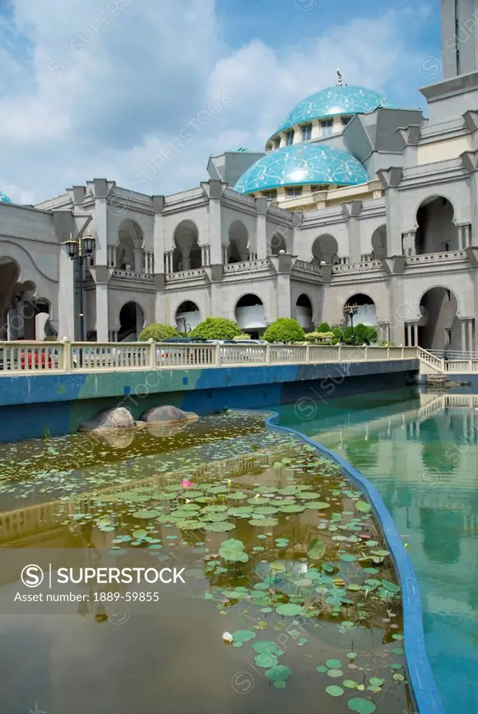 Kuala Lumpur, Malaysia, A Building With Archways, A Blue Dome Roof And Water Around It