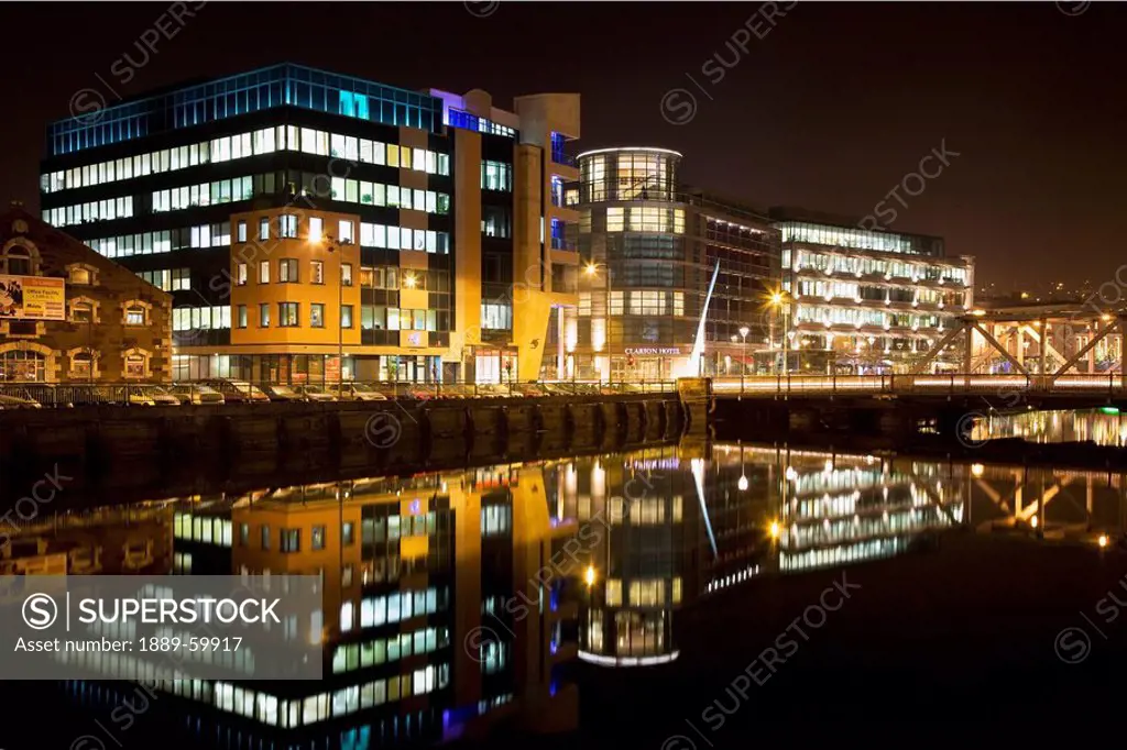 Cork, Cork County, Ireland, The Old And The New Parts Of Cork City Illuminated At Night Along River Lee