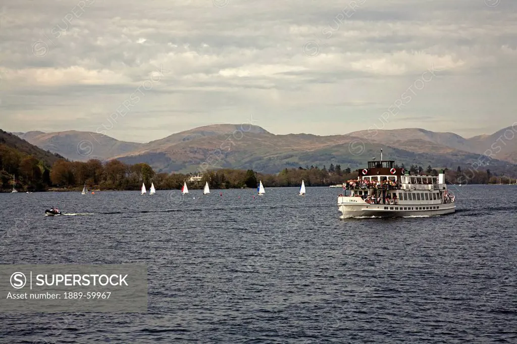 Windermere, Cumbria, England, A Steamer Boat Traveling With Passengers In Lake District National Park
