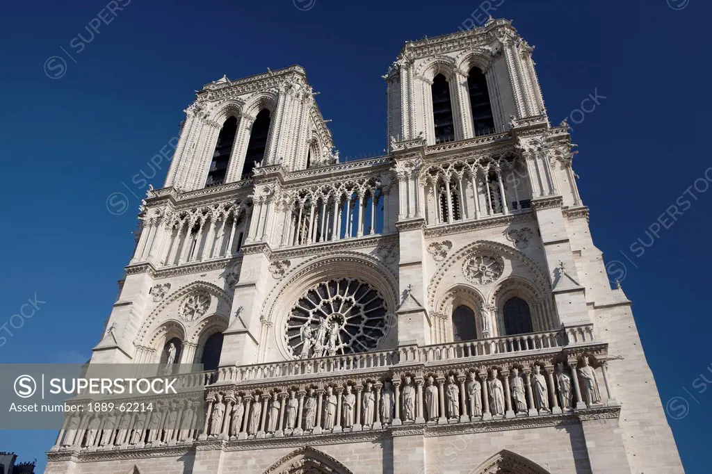 cathedral towers and facade with a blue sky background, paris, france