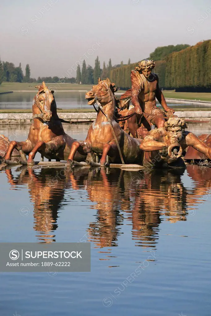 statue of horses and men reflected in water, paris, france
