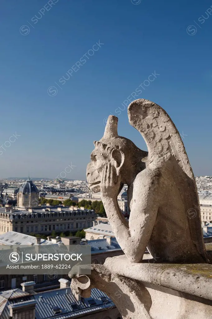 gargoyle overlooking paris with it´s tongue sticking out, paris, france