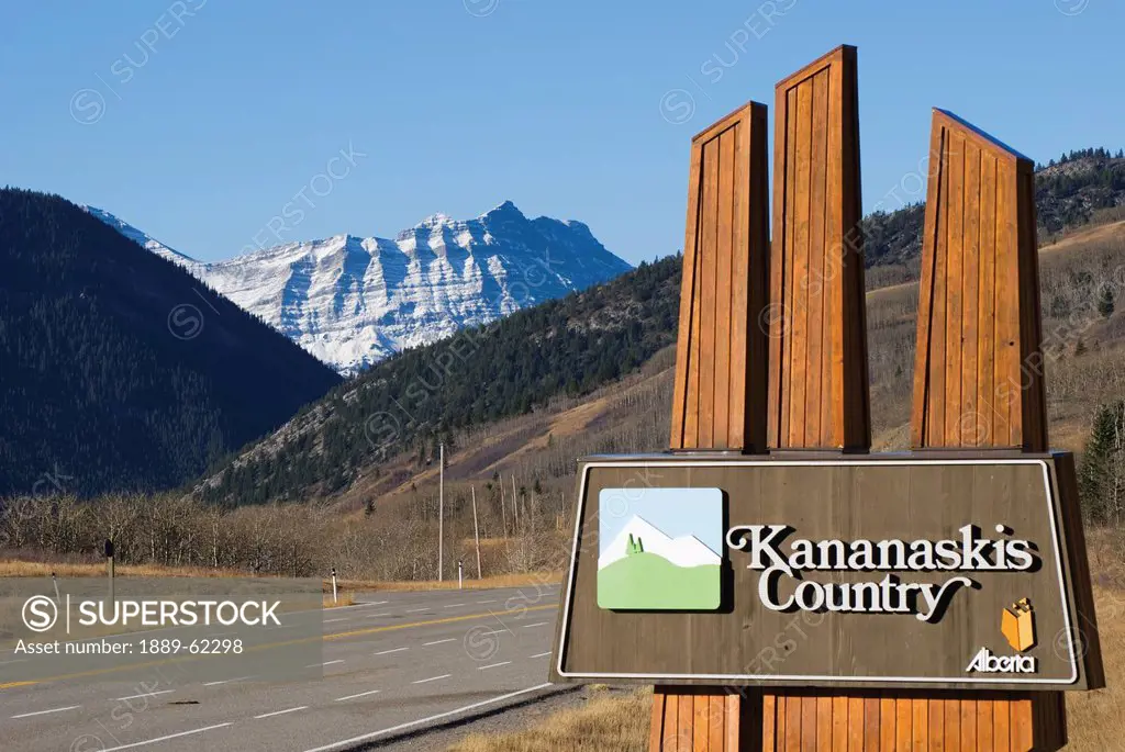 kananaskis country road sign with the mountains in the distance, kananaskis, alberta, canada