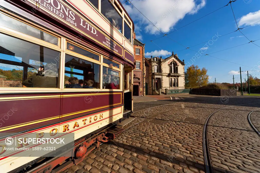 a rail car traveling on the tracks in the town, beamish, durham, england