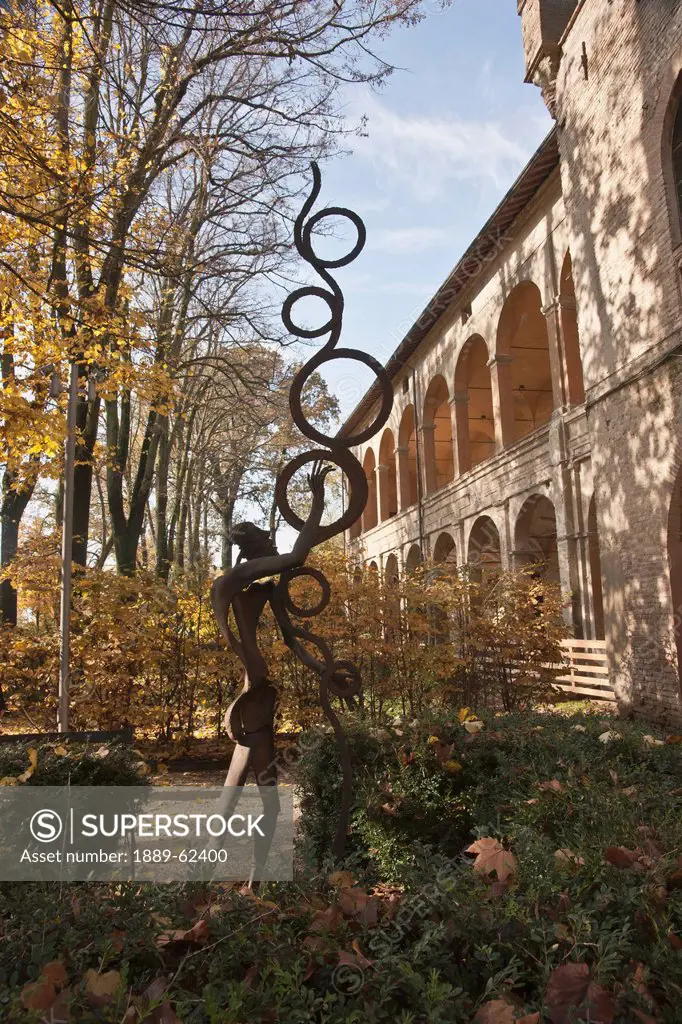 a metal sculpture in a garden outside rocca dei rossi castle, san secondo parmense, italy