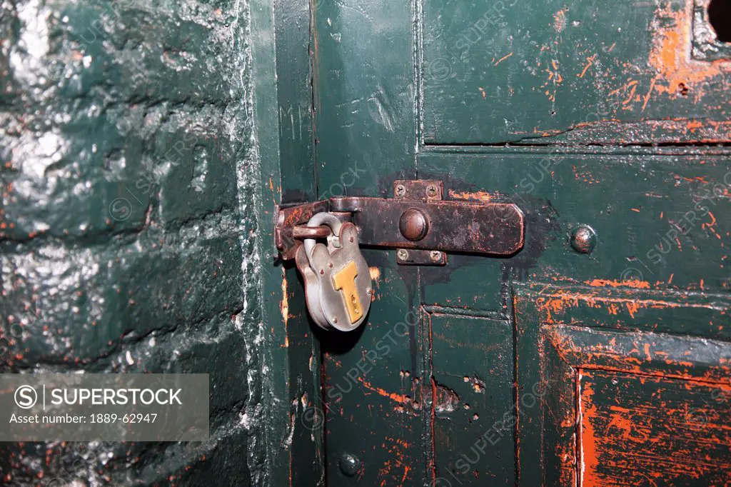 an old door and padlock in kilmainham jail, dublin, dublin county, ireland