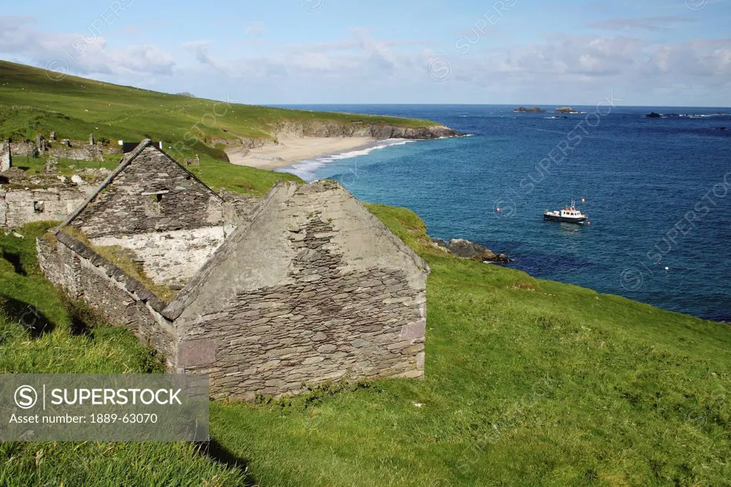ruined stone cottages on blasket island along the coast in munster region, county kerry, ireland