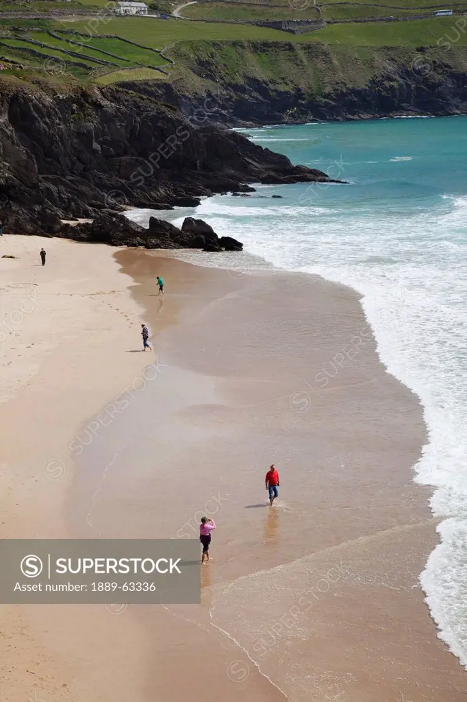 people by the seashore, coumeenole beach, dunquin, county kerry, ireland