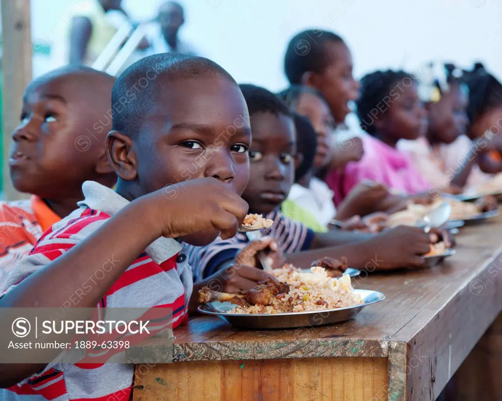 children eating a hot meal, port_au_prince, haiti