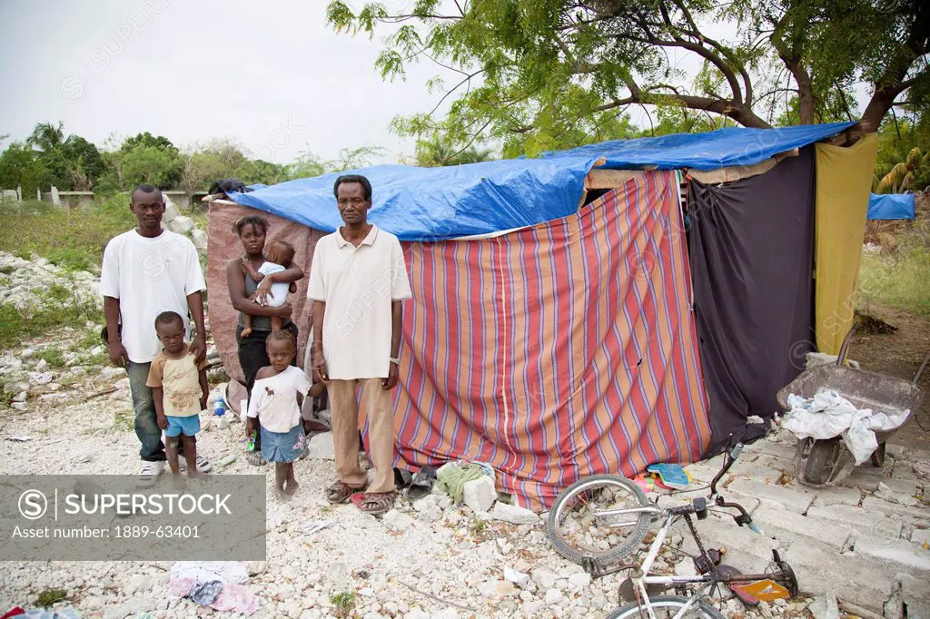 a family stands in front of their temporary shelter following the aftermath of the haitian earthquake, port_au_prince, haiti