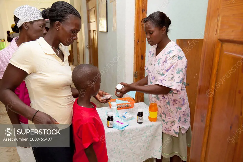 a family arrives at a clinic, grand saline, haiti
