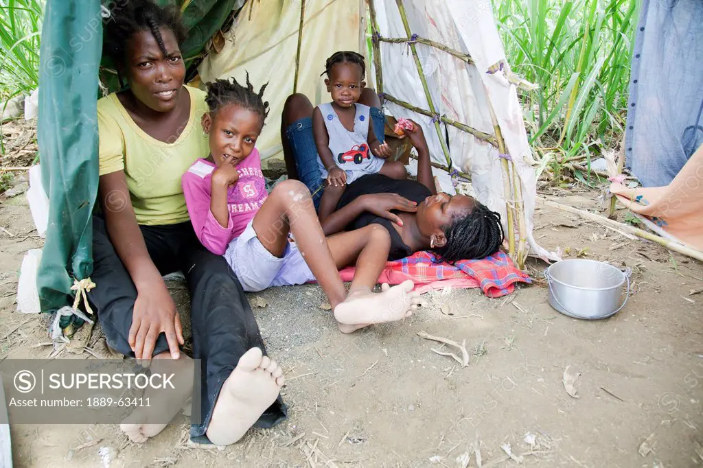 bed sheets and plastic are now home for a young family, port_au_prince, haiti