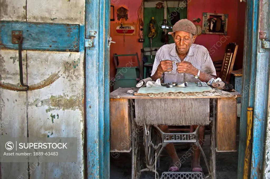 a haitian watch and clock repairman who has served his community for decades, grand goave, haiti
