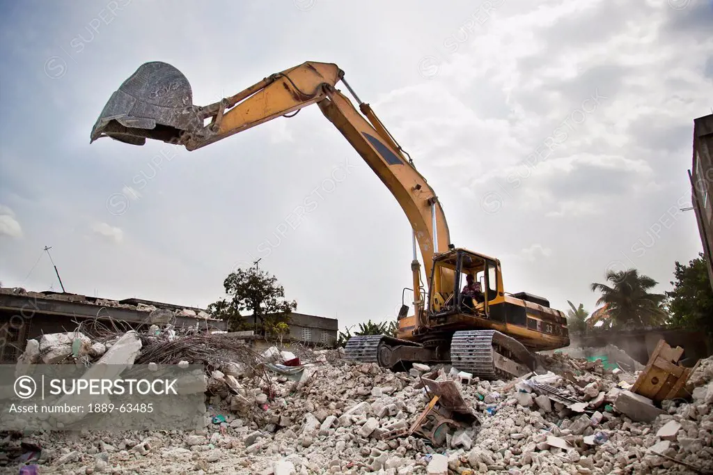 a backhoe cleaning up the destruction from the earthquake, port_au_prince, haiti
