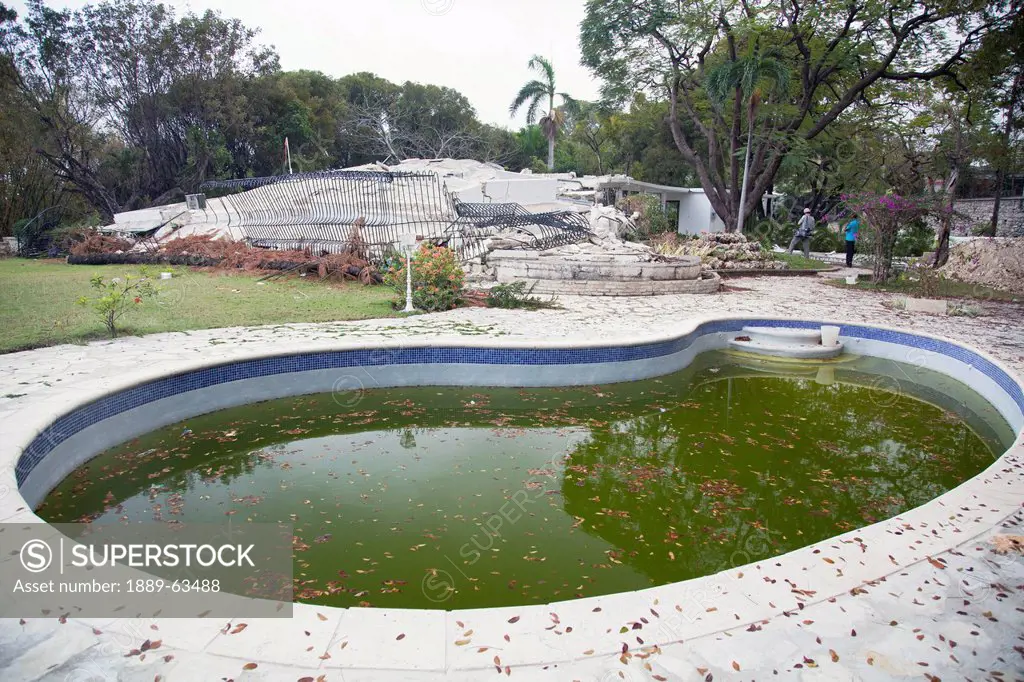 a previously luxurious haitian home with a stagnant swimming pool after the earthquake, port_au_prince, haiti