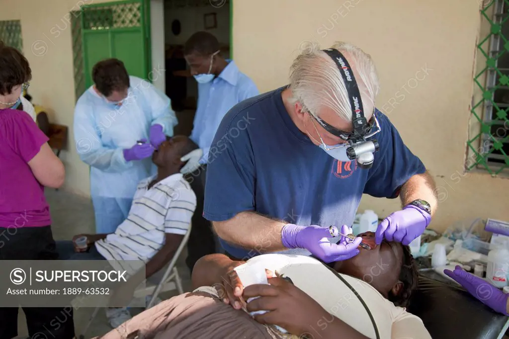 dentists volunteer their time and talent to give relief to haitians living in poverty, grand saline, haiti