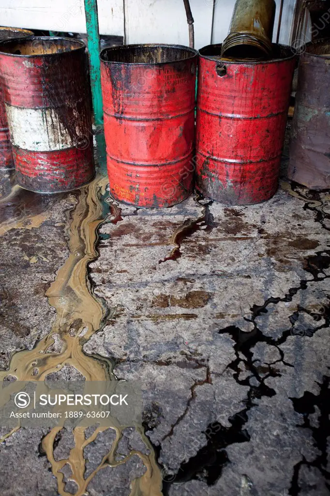 barrels of molasses, a byproduct of manufacturing raw sugar from sugar cane, sit and leak inside the ursumco universal robina sugar milling corporatio...