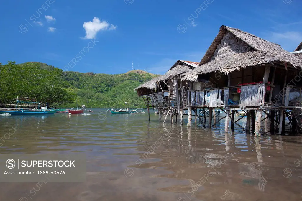 old stilt houses sit in the bay near the tiny fishing village of vigan near snake island and el nido, vigan, bacuit archipelago, palawan, philippines