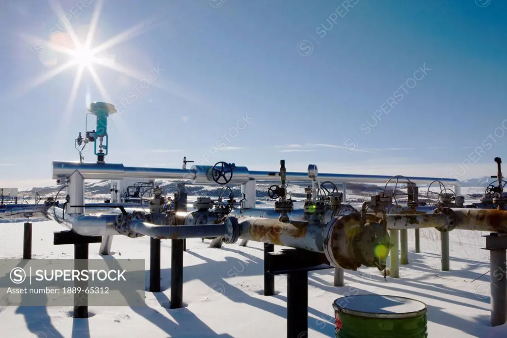 oil industry pipes in winter, longview, alberta, canada