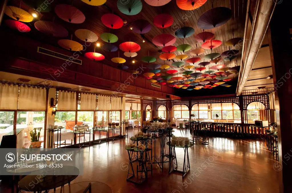 umbrellas hanging from the ceiling at the restaurant in amari rincome hotel, chiang mai thailand