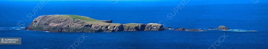 an island viewed from sumburgh head, shetland scotland