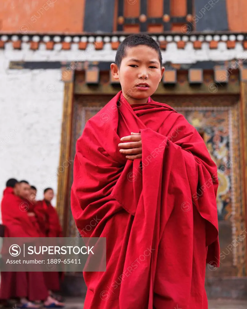 A Young Monk In A Red Robe At Rinpung Dzong, Paro District Bhutan