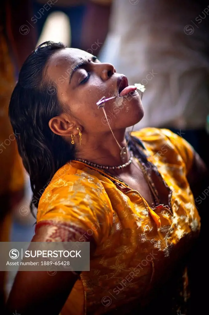 A Young Woman Performing A Hindu Ritual For The Thaipusam Festival, George Town Penang Malaysia