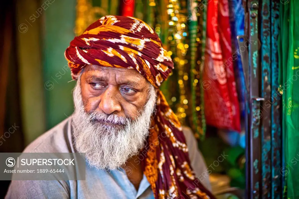 A Man Sells Ornate Cloth To Be Placed On The Tomb Of Nizamuddin In An Act Of Worship, India
