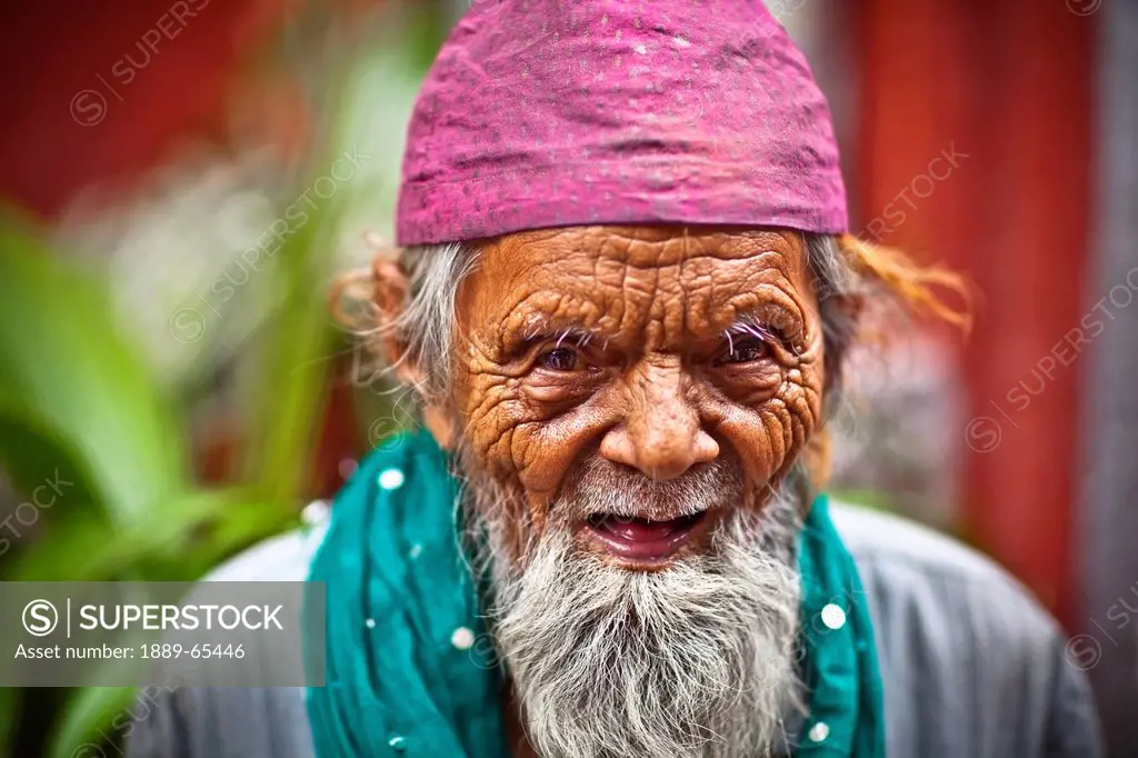 An Elderly Muslim Man Wearing A Pink Prayer Cap, India