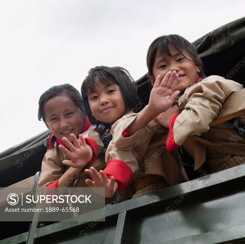 Three Military Family Schoolchildren Waving At Camera, Shaba Bhutan