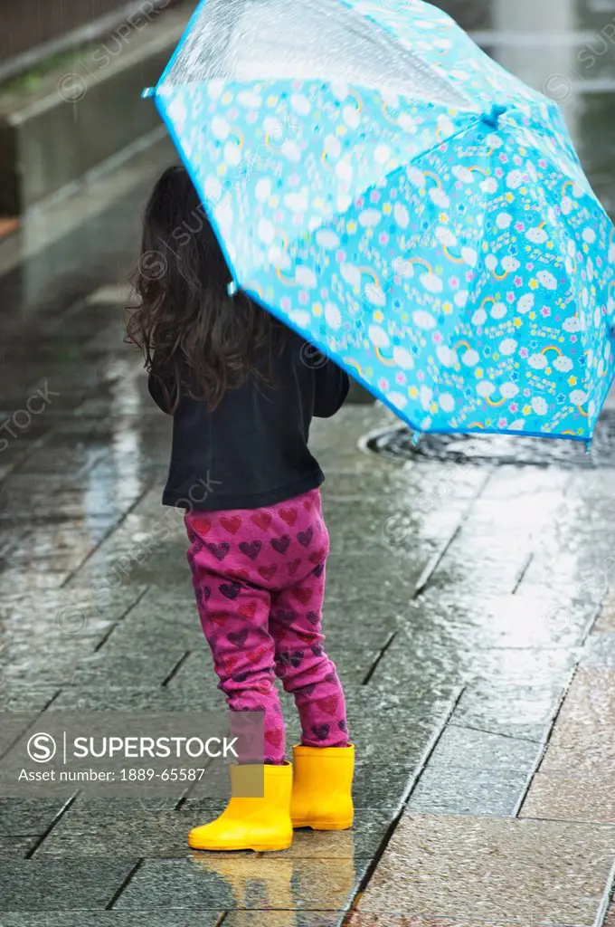 young girl with umbrella in the rain, tokyo, japan