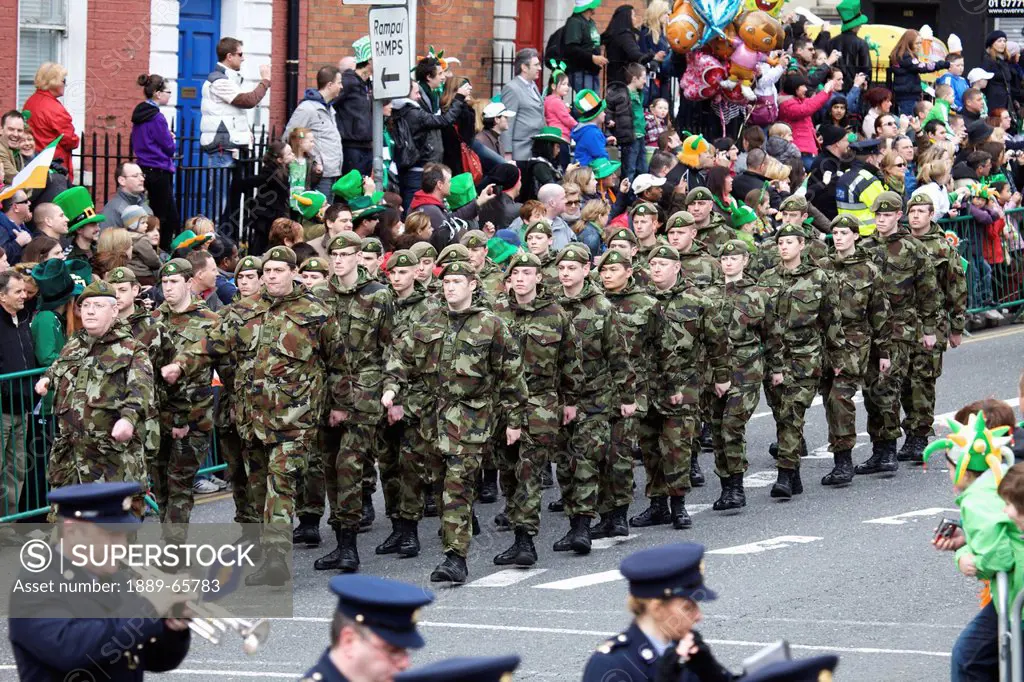 a military march and marching band in the saint patrick´s day parade, dublin ireland