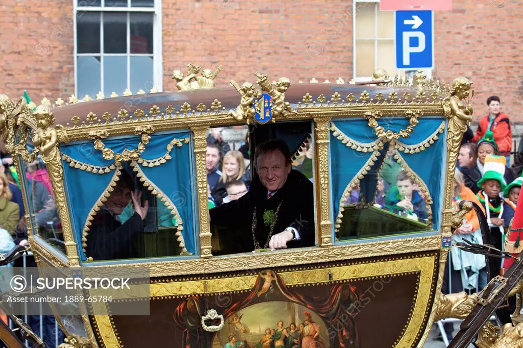 men riding in a carriage float in the saint patrick´s day parade, dublin ireland