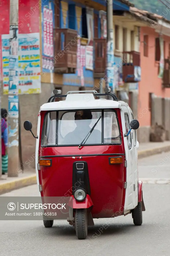 A Motorized Vehicle Traveling Down The Street, Cusco Peru