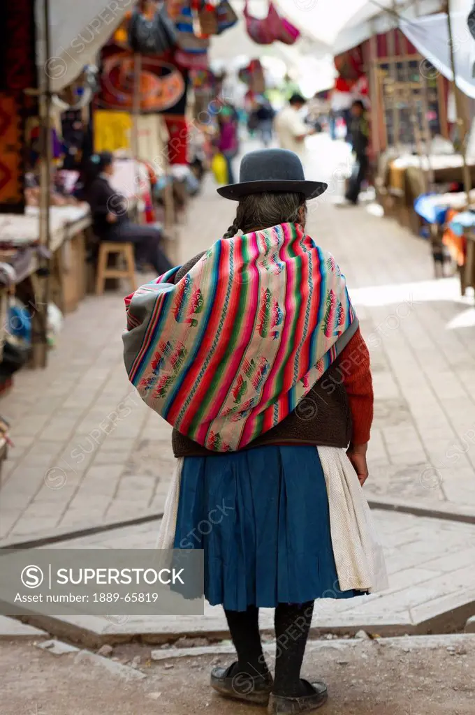 A Woman In The Market Carrying A Bundle On Her Back, Cusco Peru