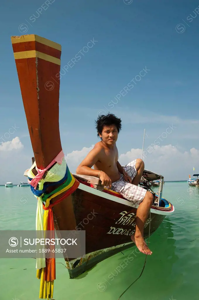man on long_tail boat, phi phi islands thailand